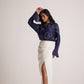 Model wearing a navy blue oversized cotton shirt with embroidery by Stylera paired with a white skirt
