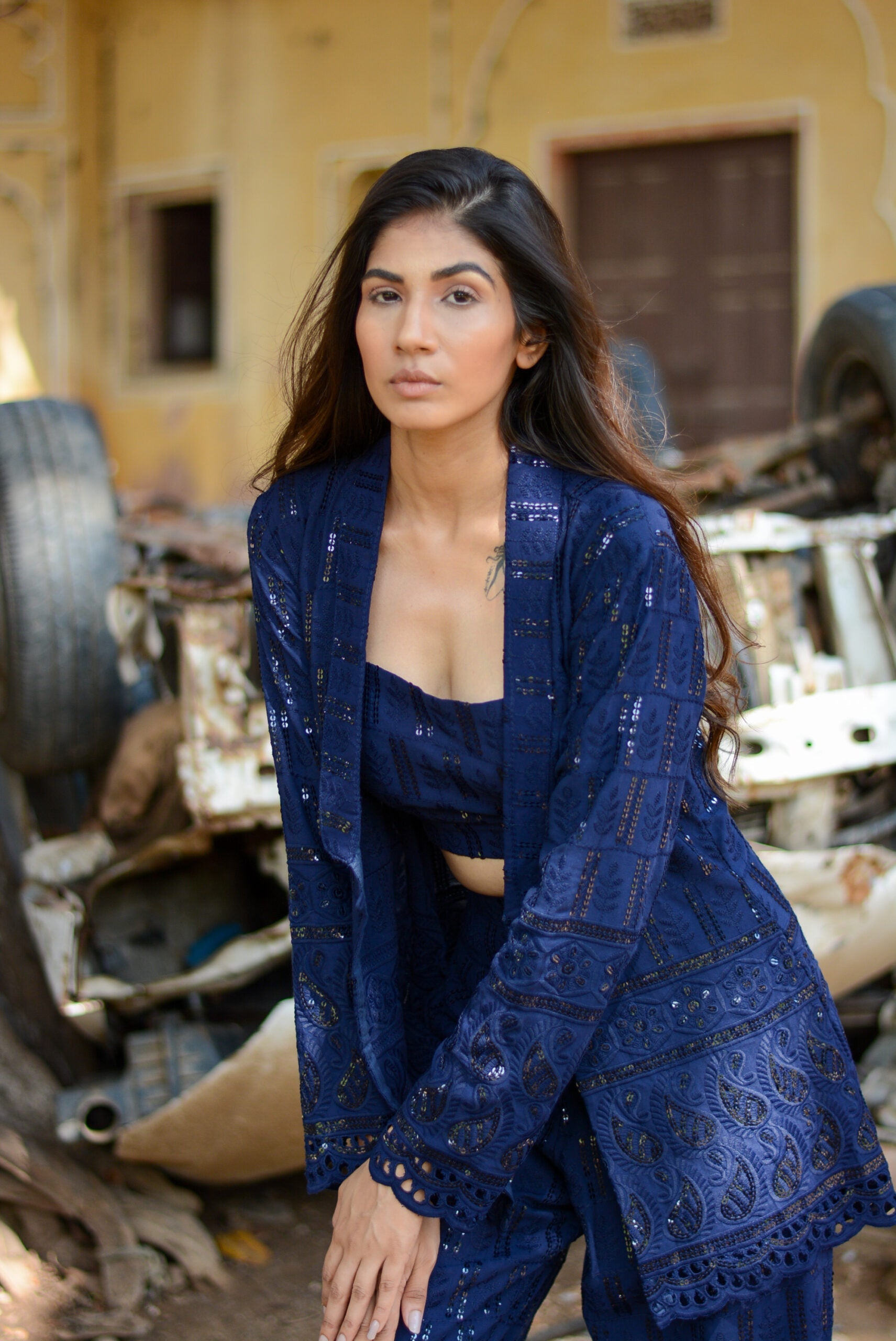 Navy blue three piece co-ord set featuring a stylish top, jacket, and pants for a chic look