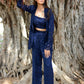 Model showcasing a navy blue three piece co-ord set with lace details and elegant styling outdoors