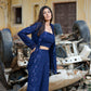Stylish model wearing a navy blue three piece co-ord set featuring a crop top and wide-leg pants