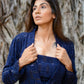 Elegant model wearing a navy blue three piece co-ord set with an open blazer and fitted top