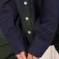 Close-up of navy green two piece matching set top with button details and long sleeves