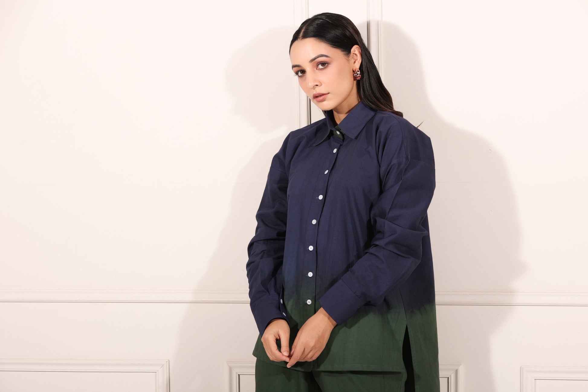 Navy green two piece matching set featuring a stylish button-up shirt and sleek pants