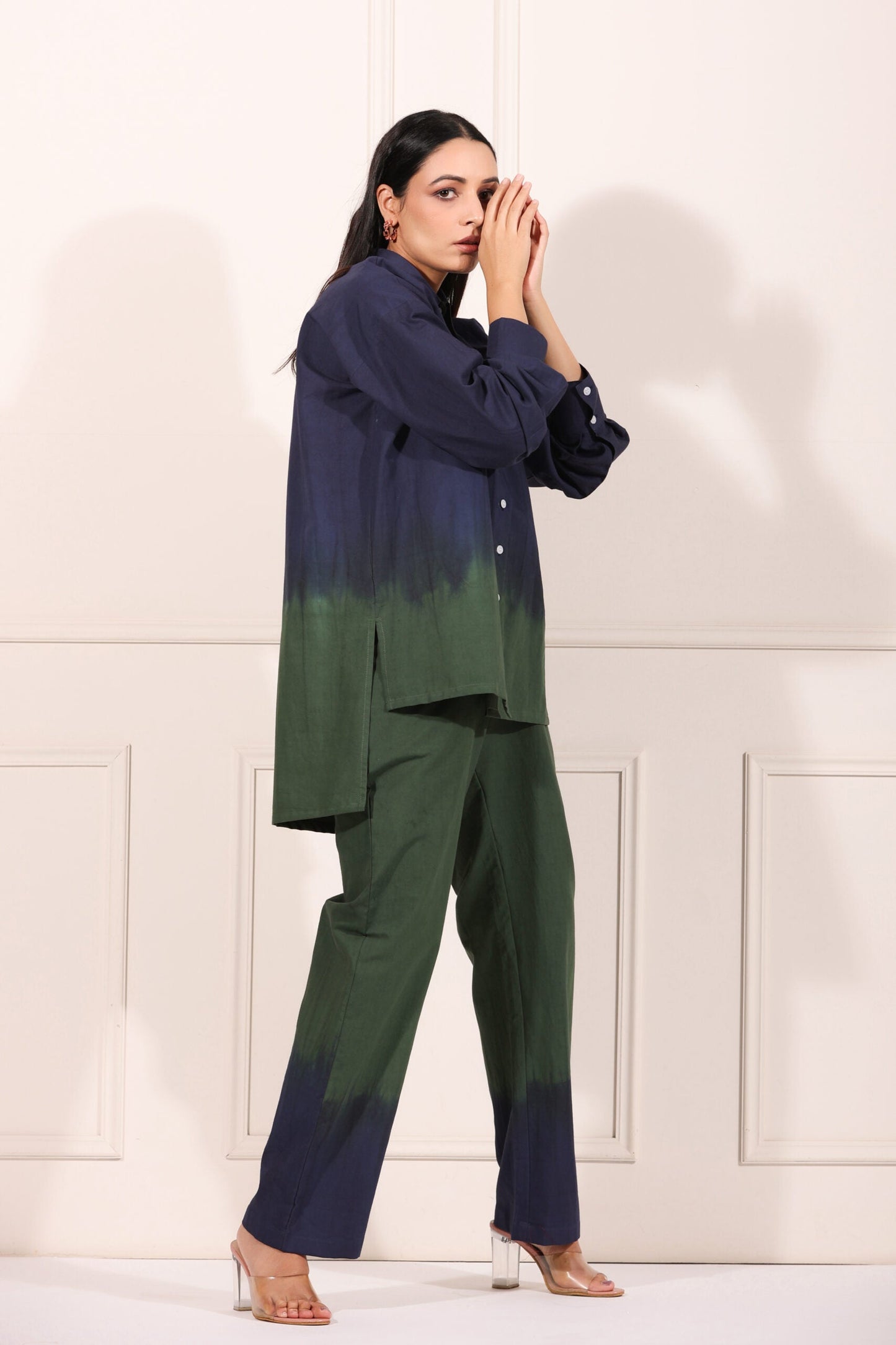 Navy green two piece matching set featuring a button-up shirt and tailored pants