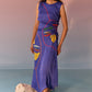 Woman wearing a navy yin yang print dress by Stylera with colorful abstract face design