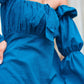Elegant off shoulder blue knot dress featuring puff sleeves and a flattering fit