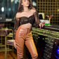 Model wearing an off shoulder brown crop top for women paired with stylish leather pants