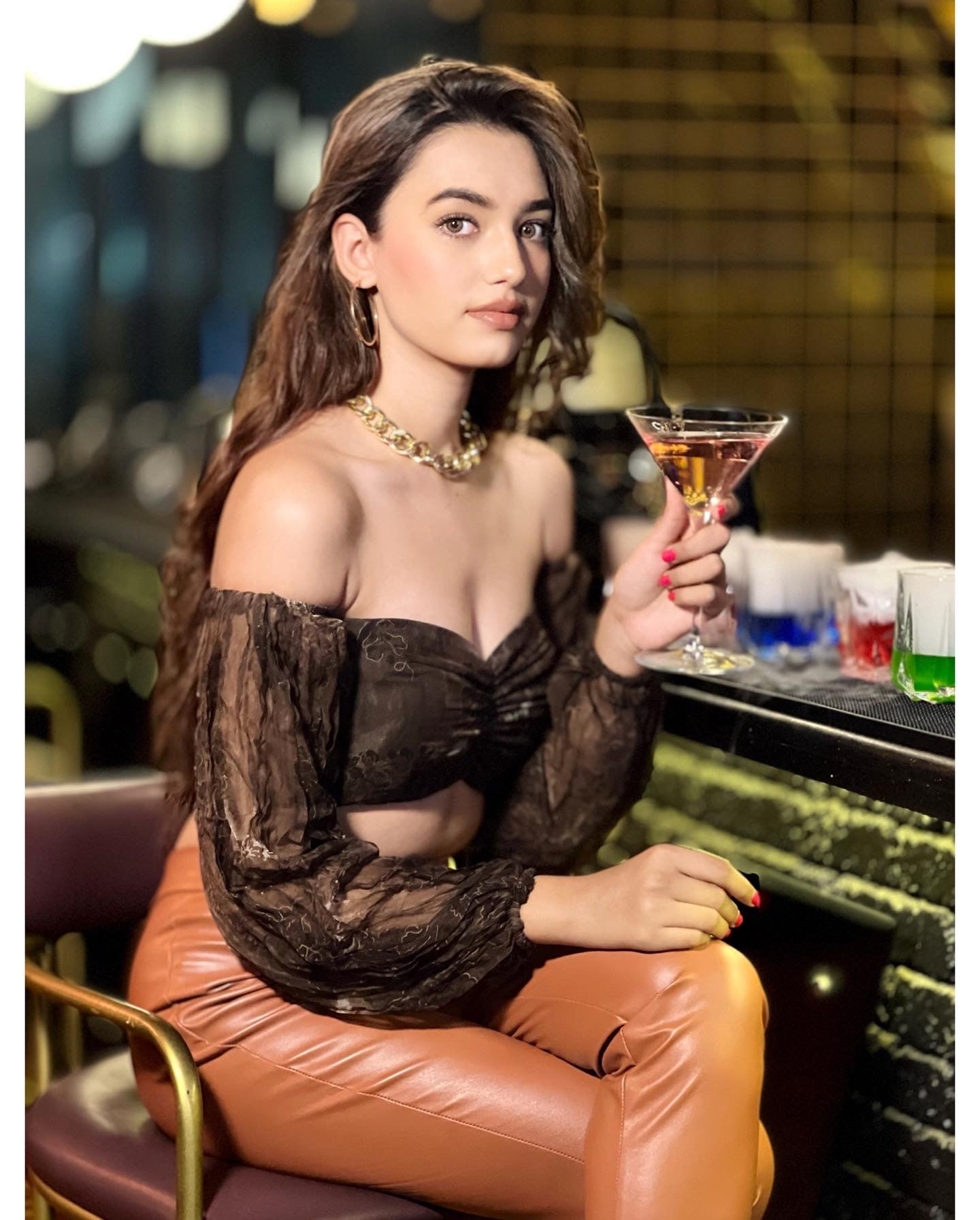 Stylish off shoulder brown crop top for women paired with high-waisted leather pants