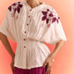 Off white embroidered cord set by Stylera featuring floral embroidery and button-up top with wide sleeves