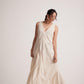 Woman wearing off-white event dress with embroidery detailing by Stylera posing gracefully