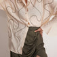 Stylera off-white oversized cotton shirt with abstract line design paired with olive green ruched skirt