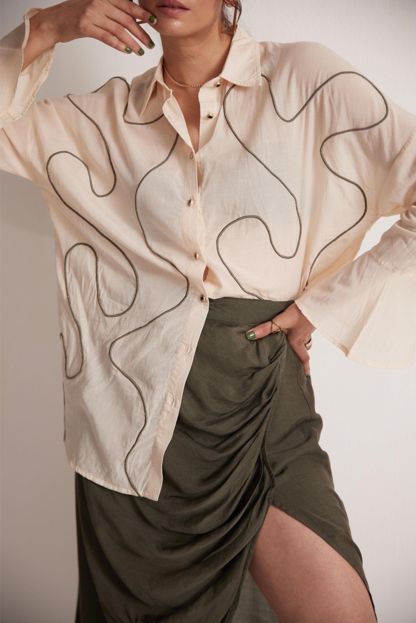Stylera off-white oversized cotton shirt with abstract line design paired with olive green ruched skirt