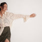 Stylera off-white oversized cotton shirt worn by model styled with a high-slit olive green skirt