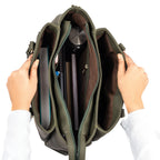 Olive green tote bag with spacious interior holding books and a laptop for daily use