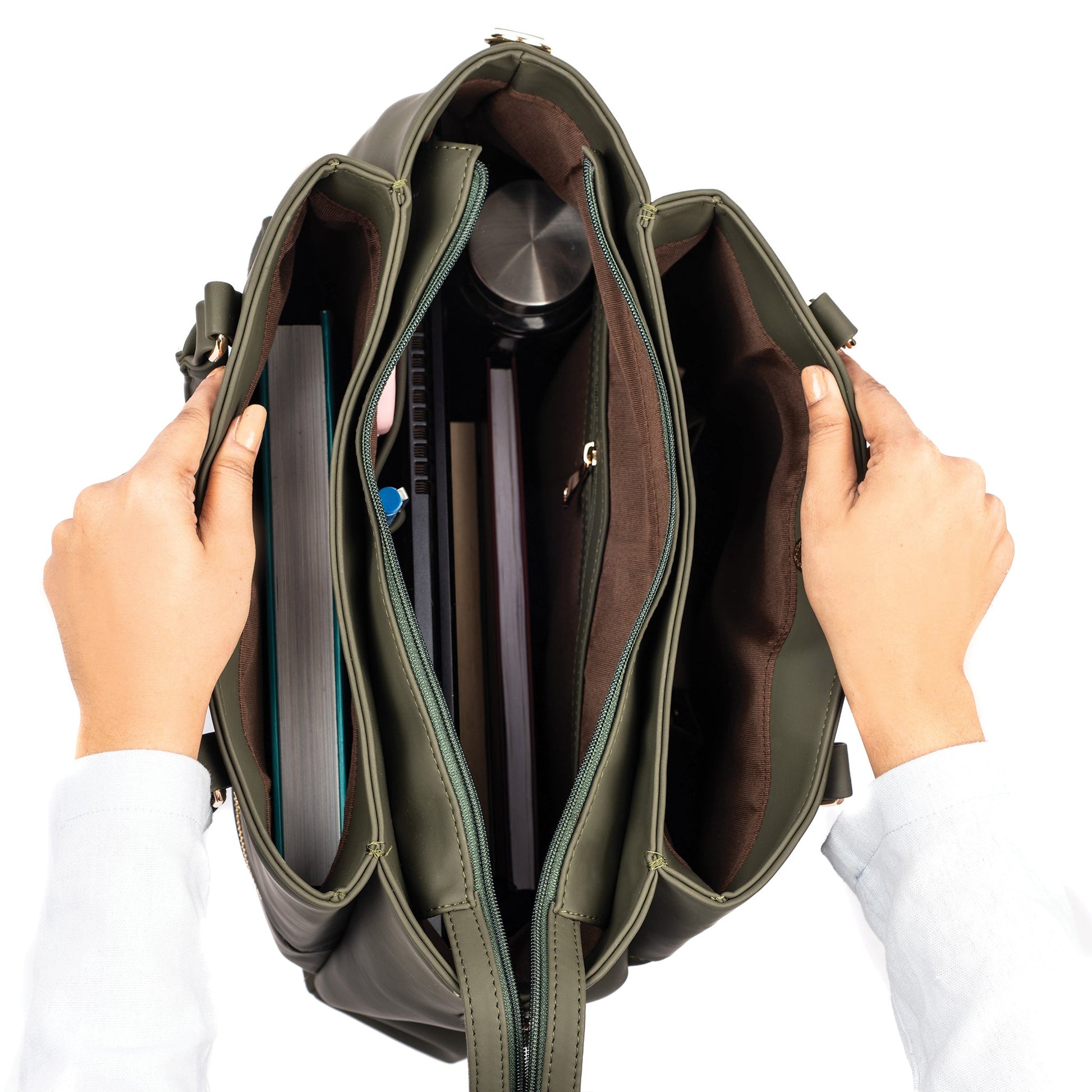 Olive green tote bag with spacious interior holding books and a laptop for daily use