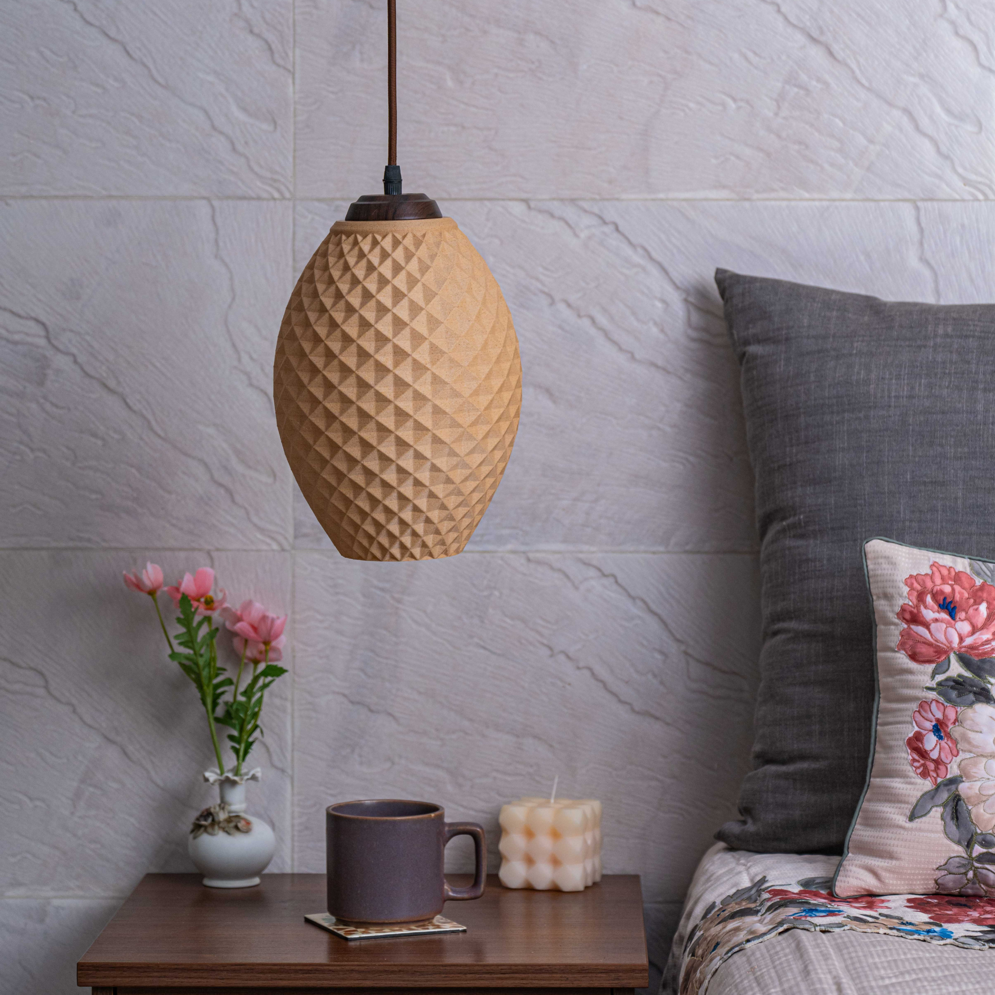 Contemporary decorative lamp for living room with geometric design, alongside a cozy couch and floral accents