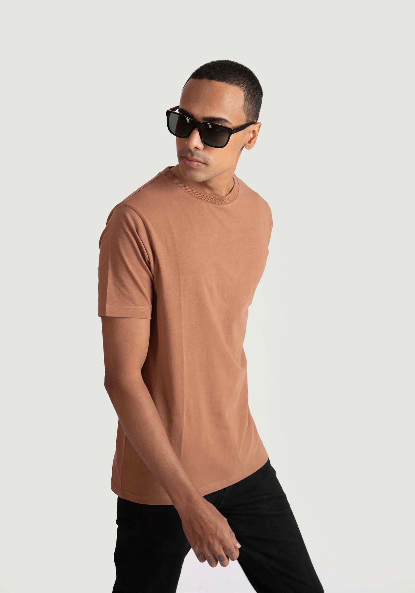 Man wearing Stylera's brown regular fit casual tee with black pants and sunglasses