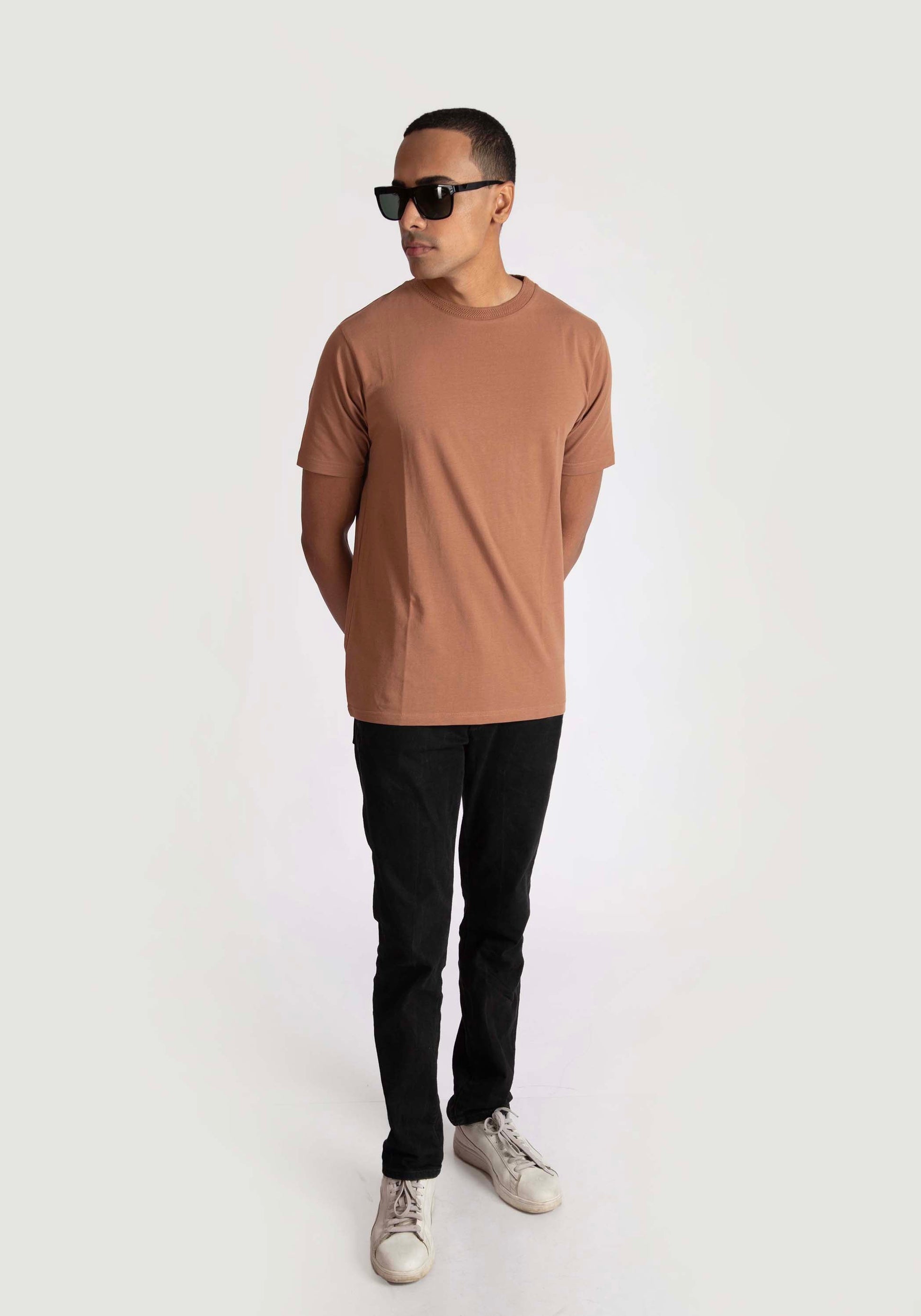 Man wearing Stylera brown regular fit casual tee with black pants and sunglasses