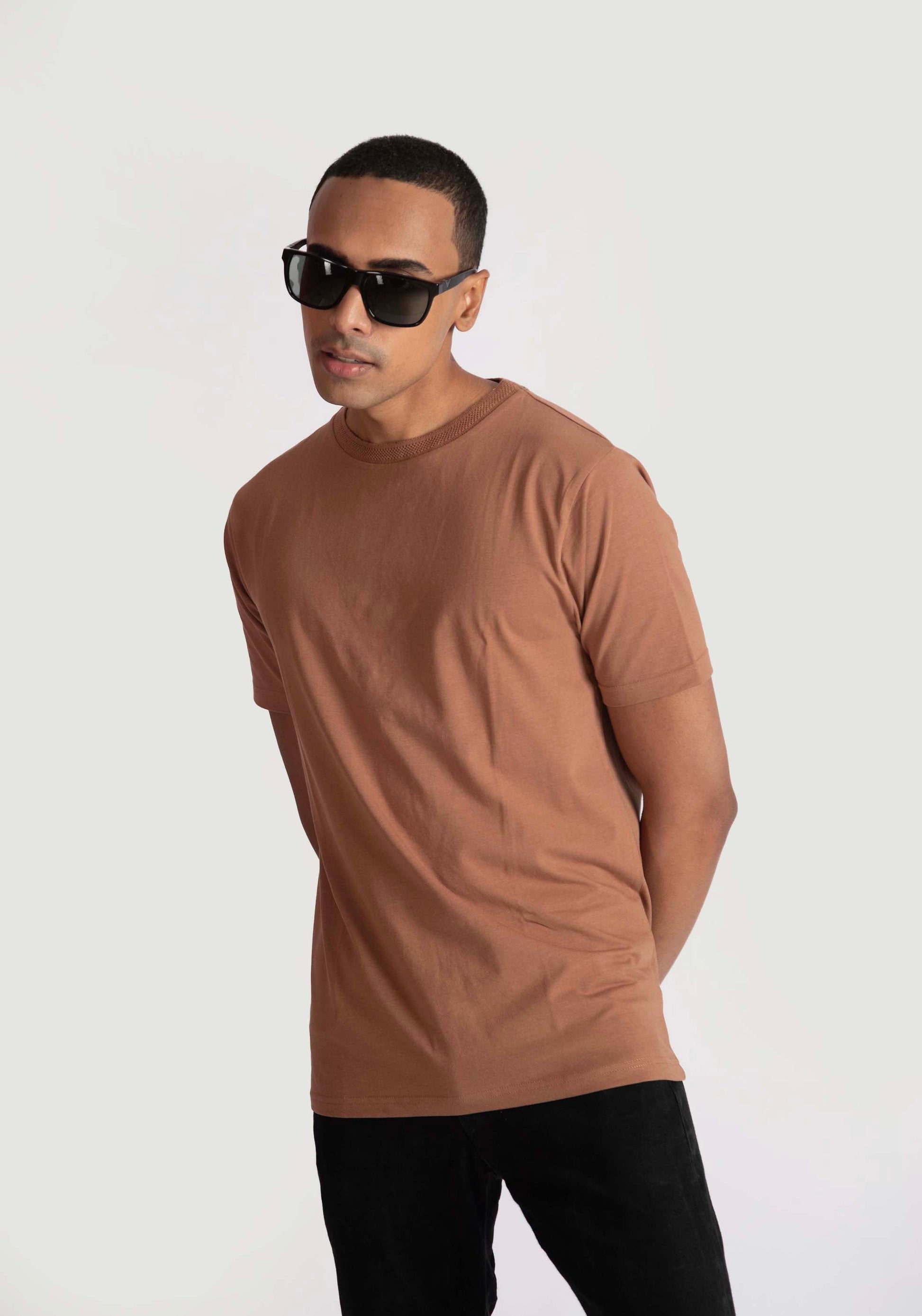 Stylera regular fit casual tee in brown worn by man with black sunglasses and black pants