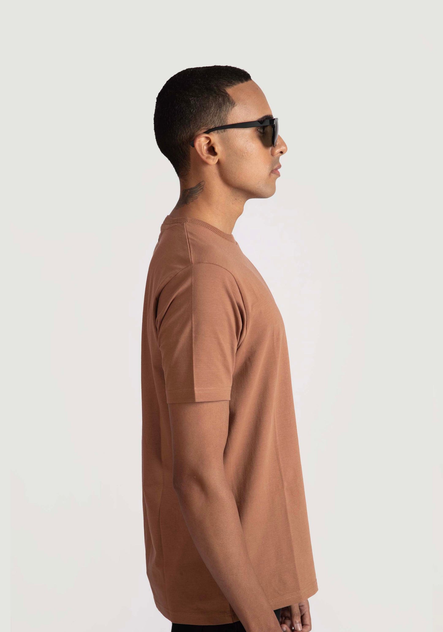 Stylera brown regular fit casual tee worn by a man in profile view with sunglasses