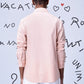 Back view of a model wearing a pink overlapping pocket shirt by Stylera 