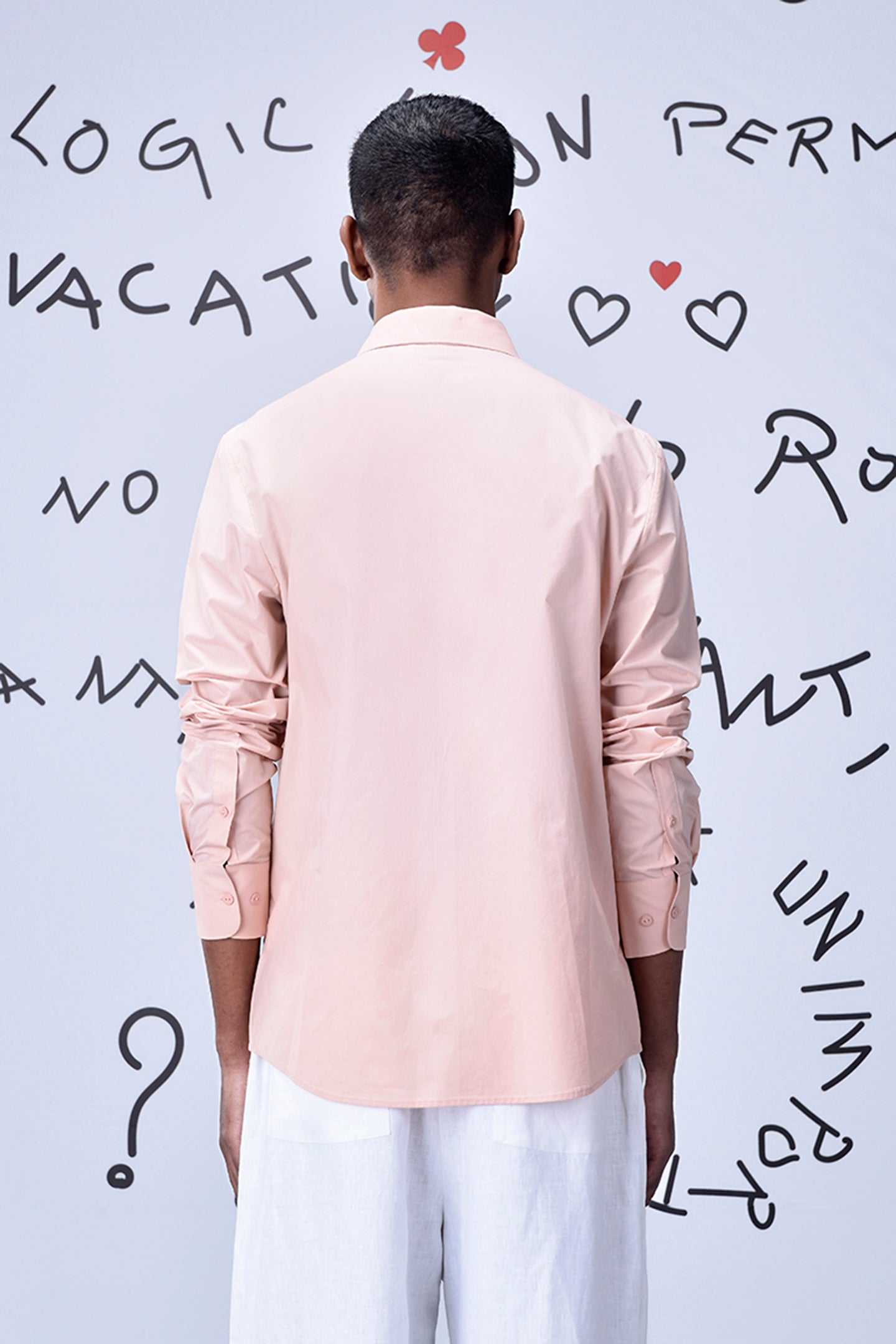 Back view of a model wearing a pink overlapping pocket shirt by Stylera 