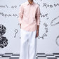 Stylera overlapping pocket shirt in light pink worn by male model with white pants