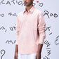 Stylera pink overlapping pocket shirt worn by male model with white pants
