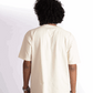 Back view of a person wearing an oversized almond milk t-shirt by Stylera in a neutral color