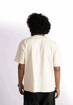 Back view of a person wearing an oversized almond milk t-shirt by Stylera in a neutral color