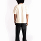 Back view of a person wearing Stylera oversized almond milk t-shirt with black pants
