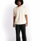 Model wearing Stylera oversized almond milk t-shirt in cream with black pants and sunglasses