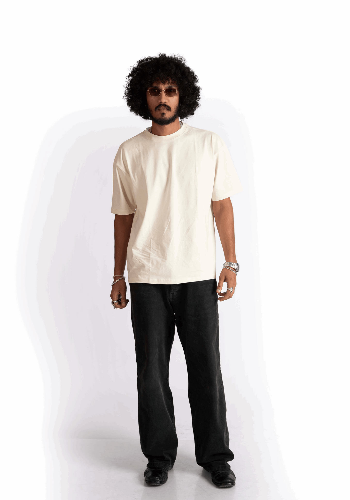 Model wearing Stylera oversized almond milk t-shirt in cream with black pants and sunglasses