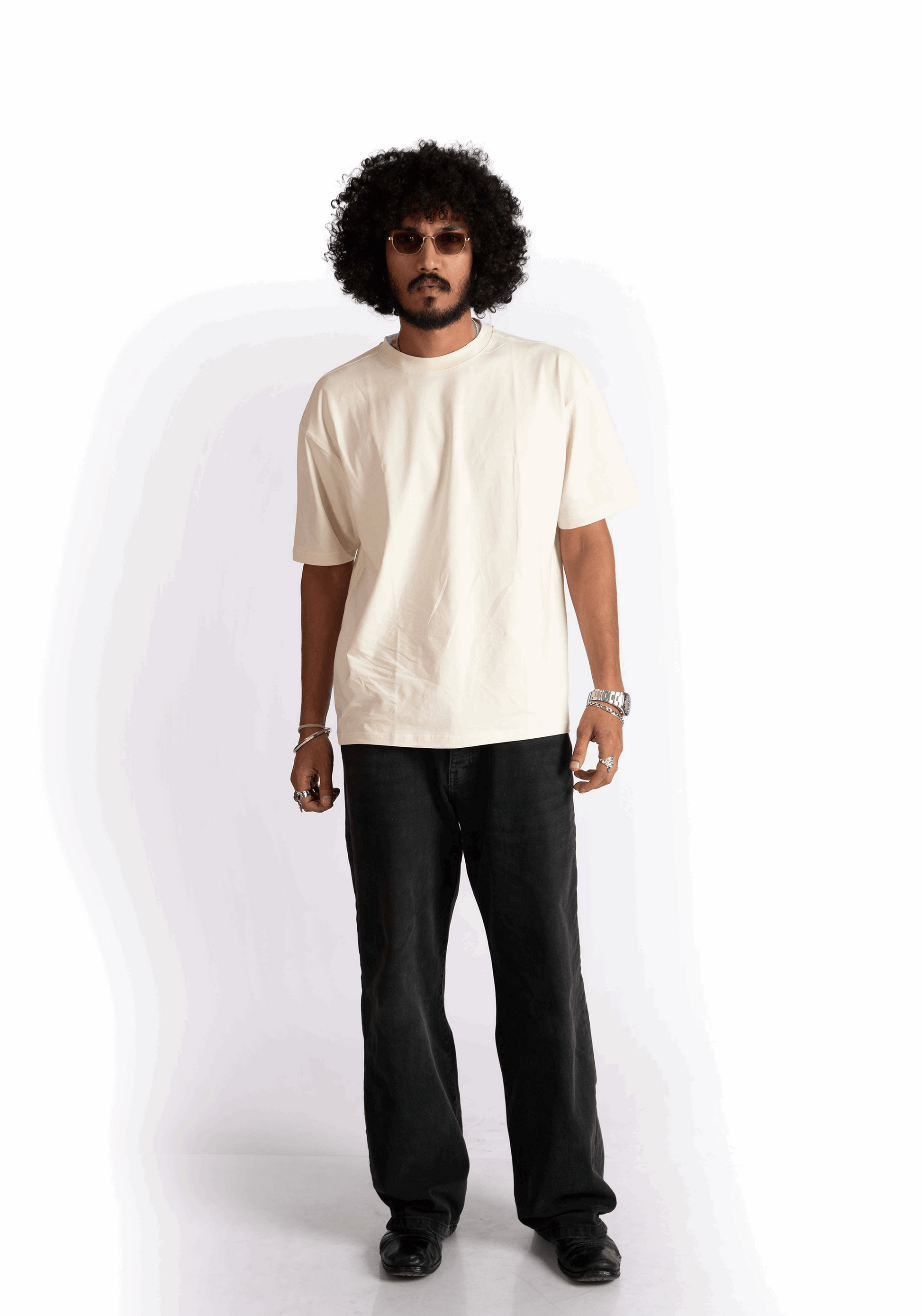 Model wearing Stylera oversized almond milk t-shirt in cream with black pants and sunglasses