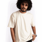 Man wearing oversized almond milk t-shirt in cream color from Stylera with sunglasses and casual style