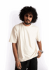 Man wearing oversized almond milk t-shirt in cream color from Stylera with sunglasses and casual style