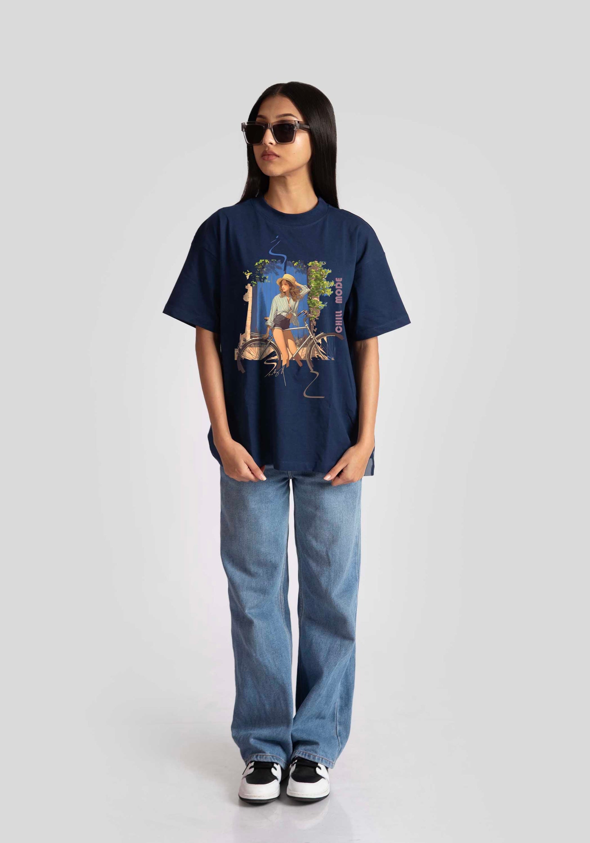 Stylera oversized blue graphic tee for womens styled with light blue jeans and sunglasses
