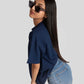Model wearing oversized blue graphic tee for womens paired with light blue jeans and sunglasses