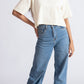 Stylera oversized crop top for women in white paired with high-waisted blue jeans