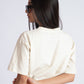 Stylera oversized crop top for women in cream color worn with blue jeans and sunglasses