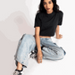 Stylera oversized cropped t-shirt for women in black worn with light blue jeans and sneakers