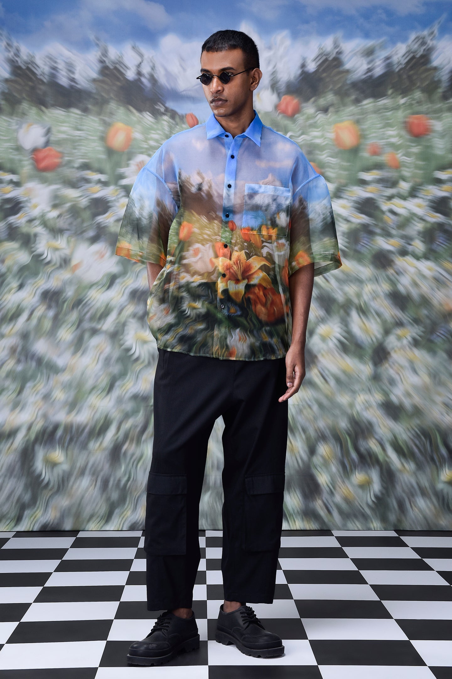 Model wearing oversized floral button up shirt by Stylera with colorful nature print