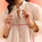 Stylera oversized off white dress with long sleeves and pink leaf embroidery details