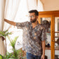 Stylish man wearing an oversized printed shirt for men with a relaxed fit and unique pattern