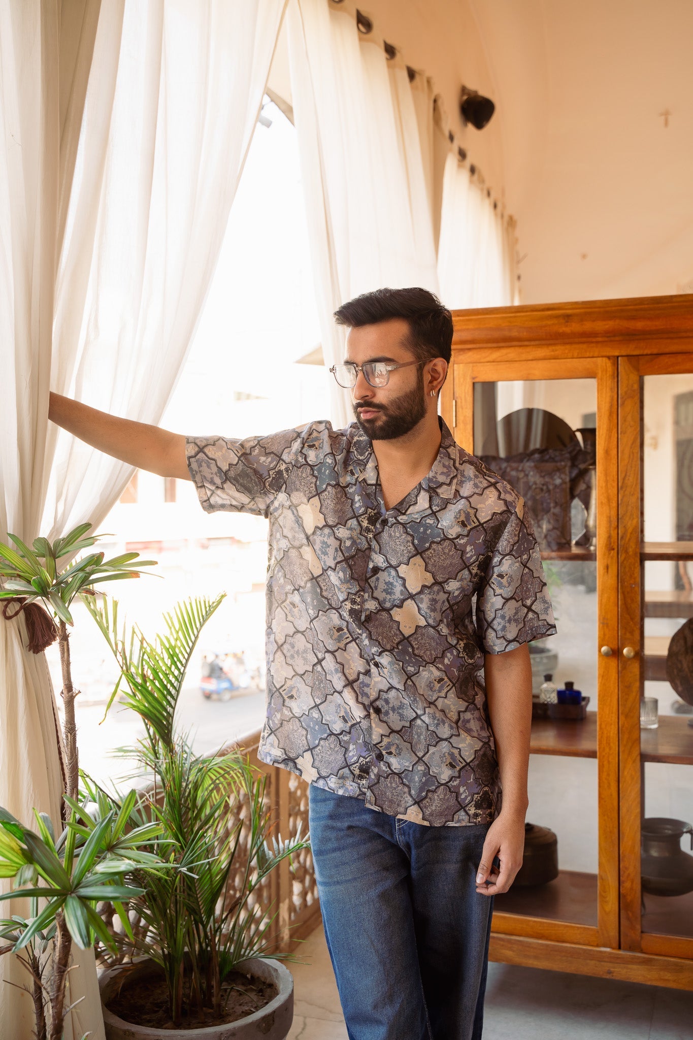 Stylish man wearing an oversized printed shirt for men with a relaxed fit and unique pattern