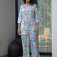 Pastel floral satin pajama set from Stylera with colorful butterfly print and relaxed fit