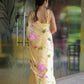 Elegant pastel yellow floral saree for women with vibrant pink flowers and delicate embroidery