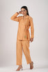 Peach Angrakha two piece outfit featuring a tie waist top and matching pants for a chic look