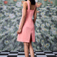 Back view of peach casual dress with lace up front by Stylera worn by model
