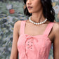 Woman wearing a peach casual dress with lace up front by Stylera